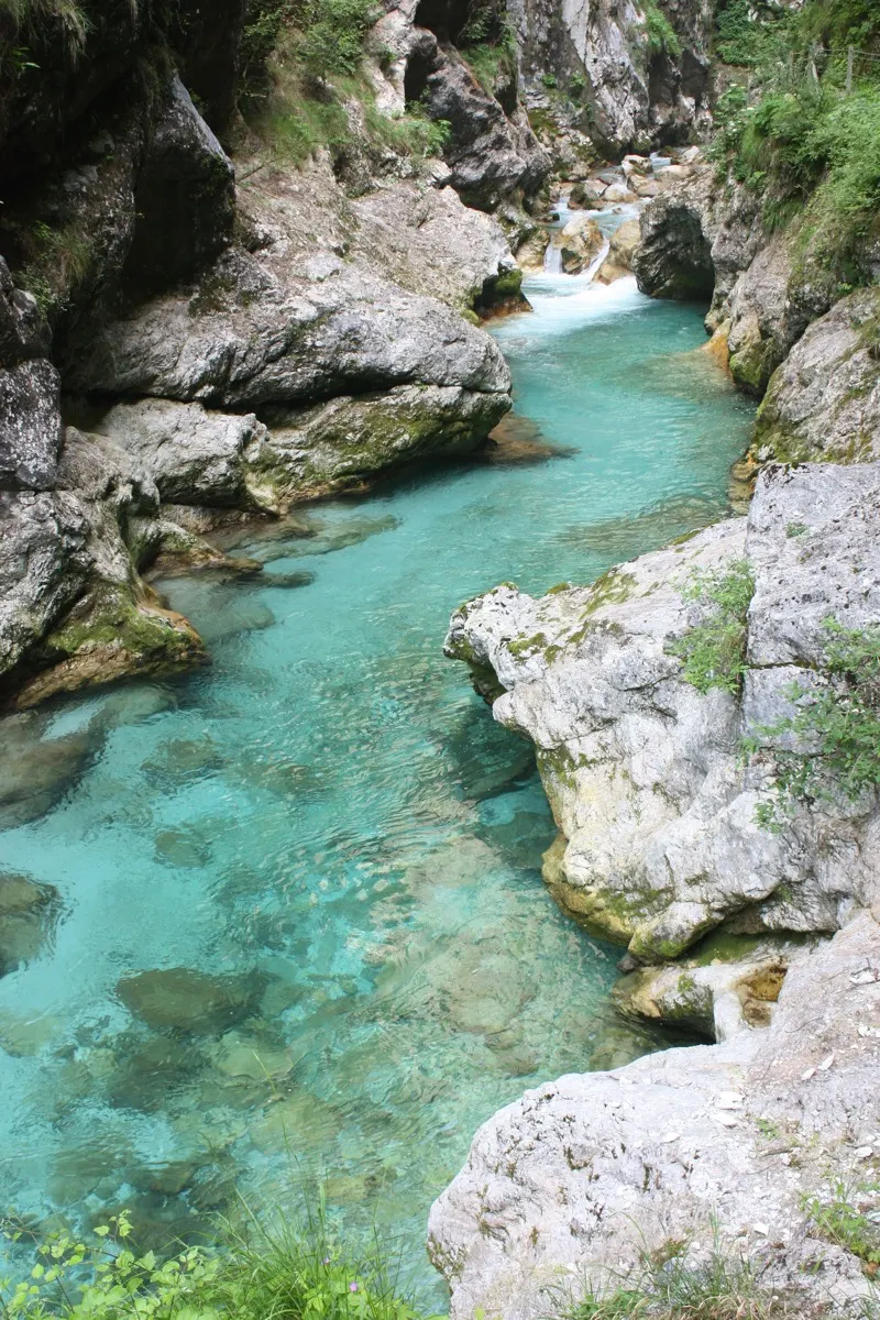 Narrow limestone gorge with deep turquoise pools on the Soča river, Slovenia